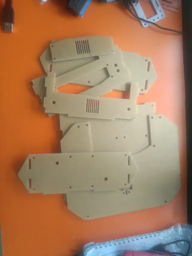 Laser-cut acrylic chassis parts laid out before assembly